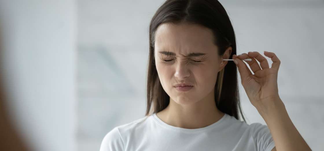 Girl cleaning out her itchy ear 