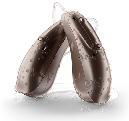 Pair of Life lumity hearing aids with droplets of water on them 