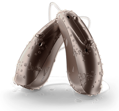 Pair of Life lumity hearing aids with droplets of water on them 