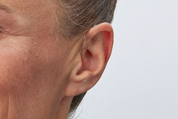 Woman wearing Oticon Intent 1 miniRITE R hearing aid
