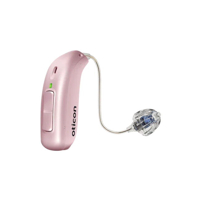 Pink hearing aid with clear tubing on a white background