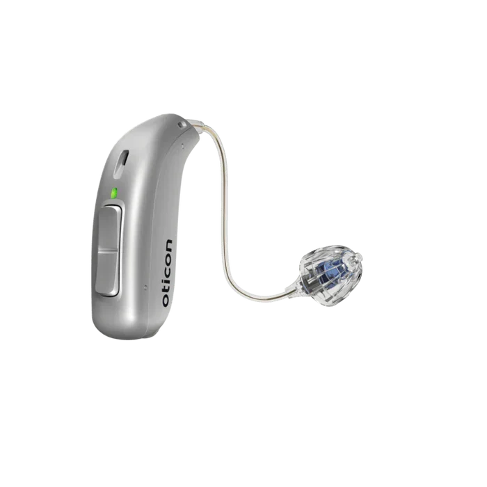Silver hearing aid with clear tubing on a white background