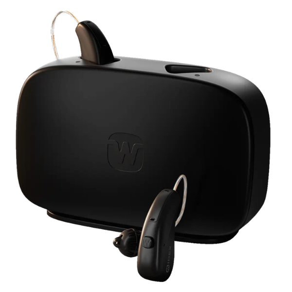 Black wireless hearing aid system with a large rectangular receiver unit, a small in-ear hearing aid, and a thin connecting tube, shown on a plain white background.