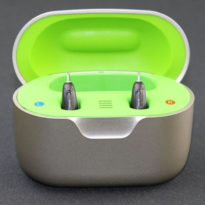 Charging case with neon green inside and hearing aids inserted