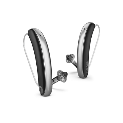 Pair of silver and black hearing aids a white background
