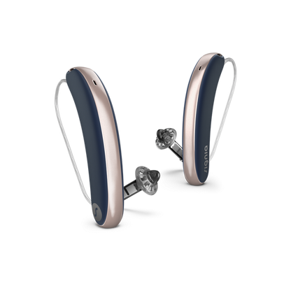 Pair of gray and silver hearing aids on a white background