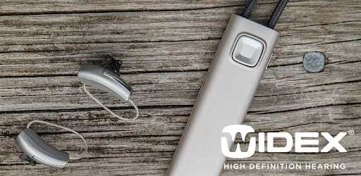 Widex hearing aids and comdex sitting on wooden table