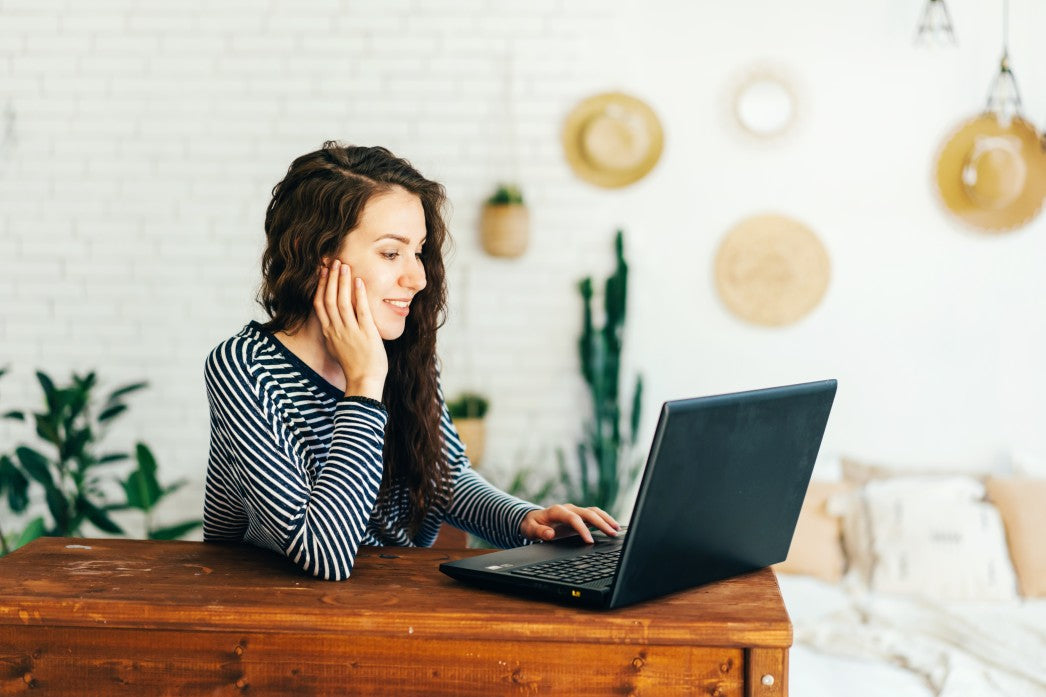Woman sitting at a desk working on her laptop 